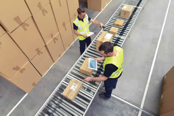 Two warehousemen scanning packages at a VAD product fullfillment
warehouse.